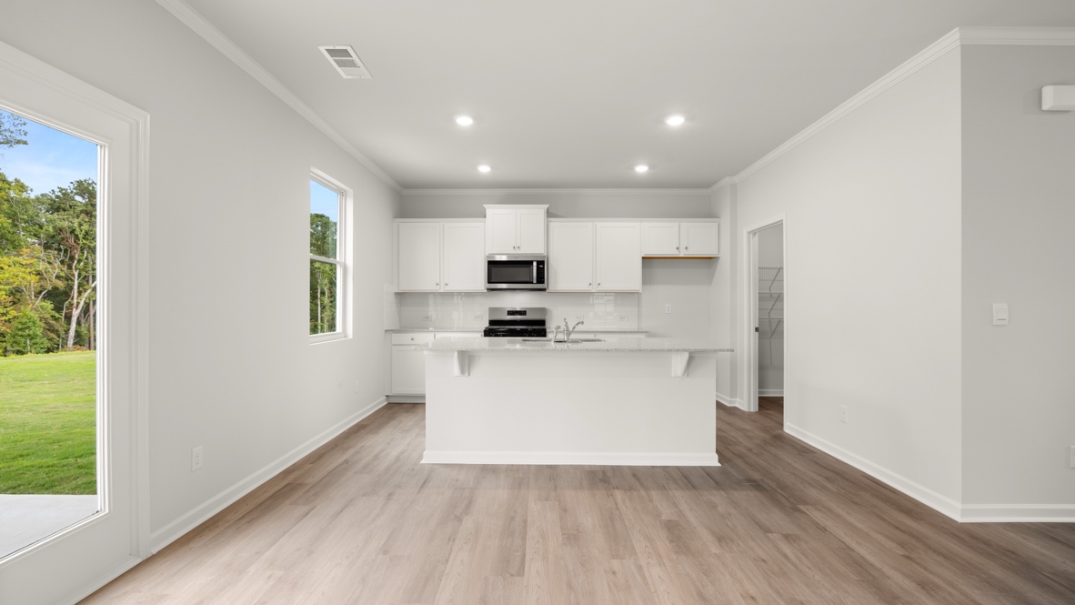 Interior kitchen with center island and white cabinets