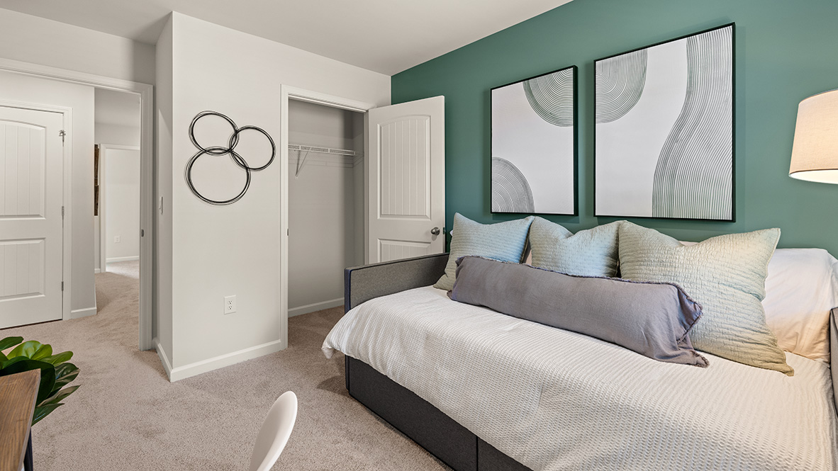 pearson secondary bedroom on the second level with a window and light carpet