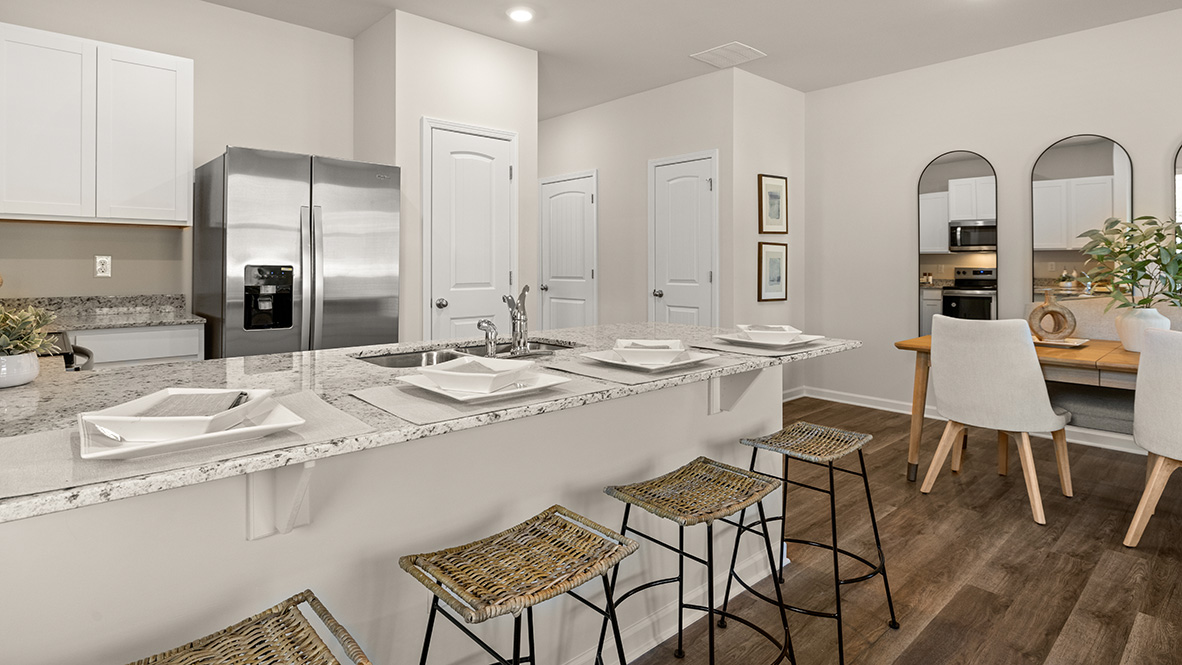 Interior kitchen with center island and white cabinets
