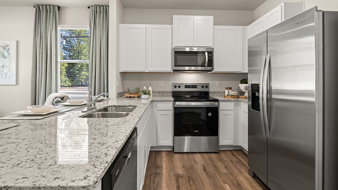 Interior kitchen with center island and white cabinets