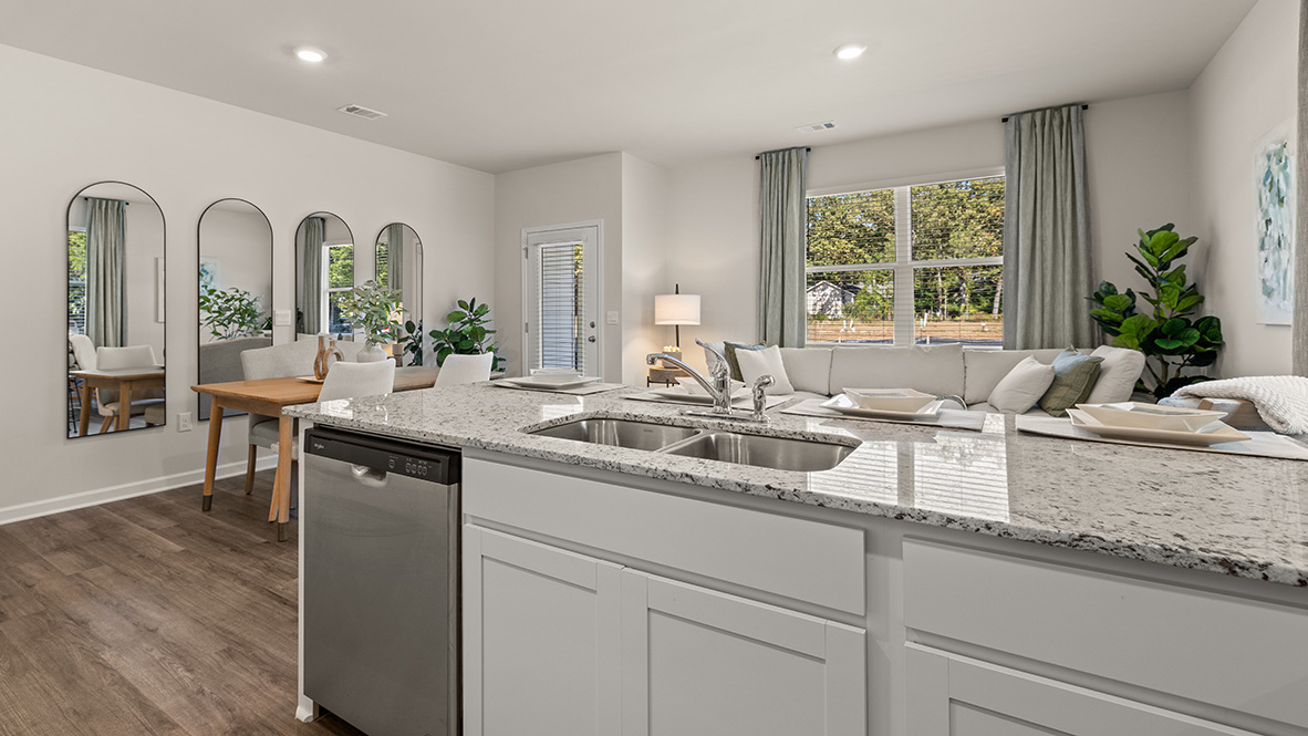 Interior kitchen with center island and white cabinets