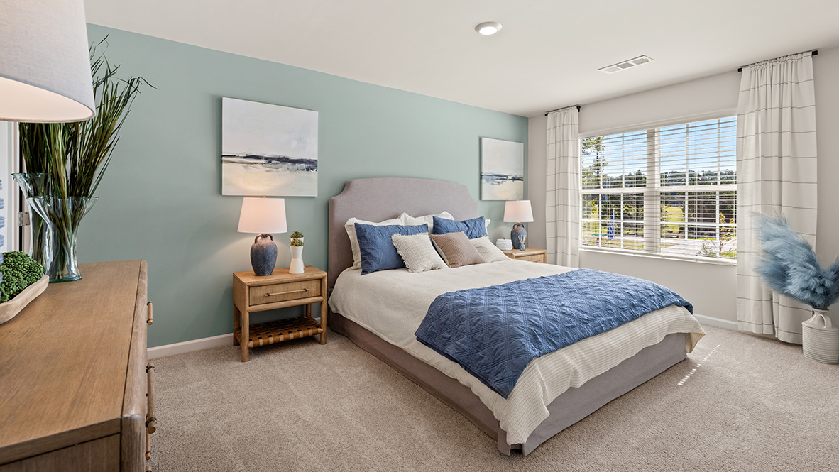 Interior primary bedroom with large window