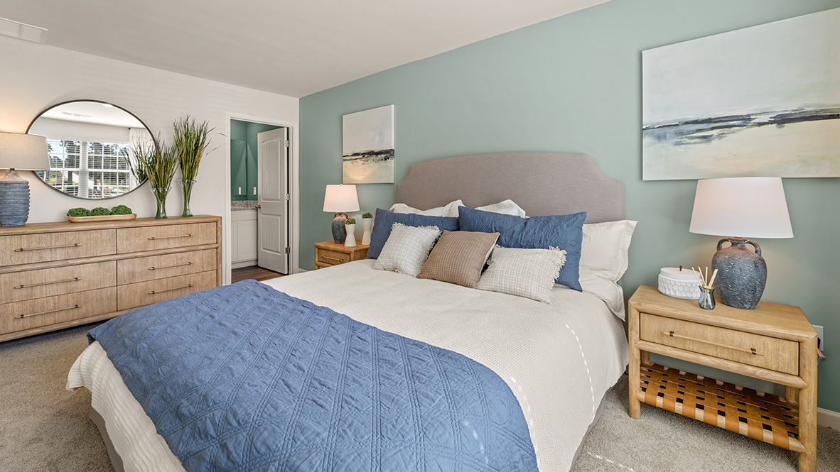 Interior primary bedroom with accent wall