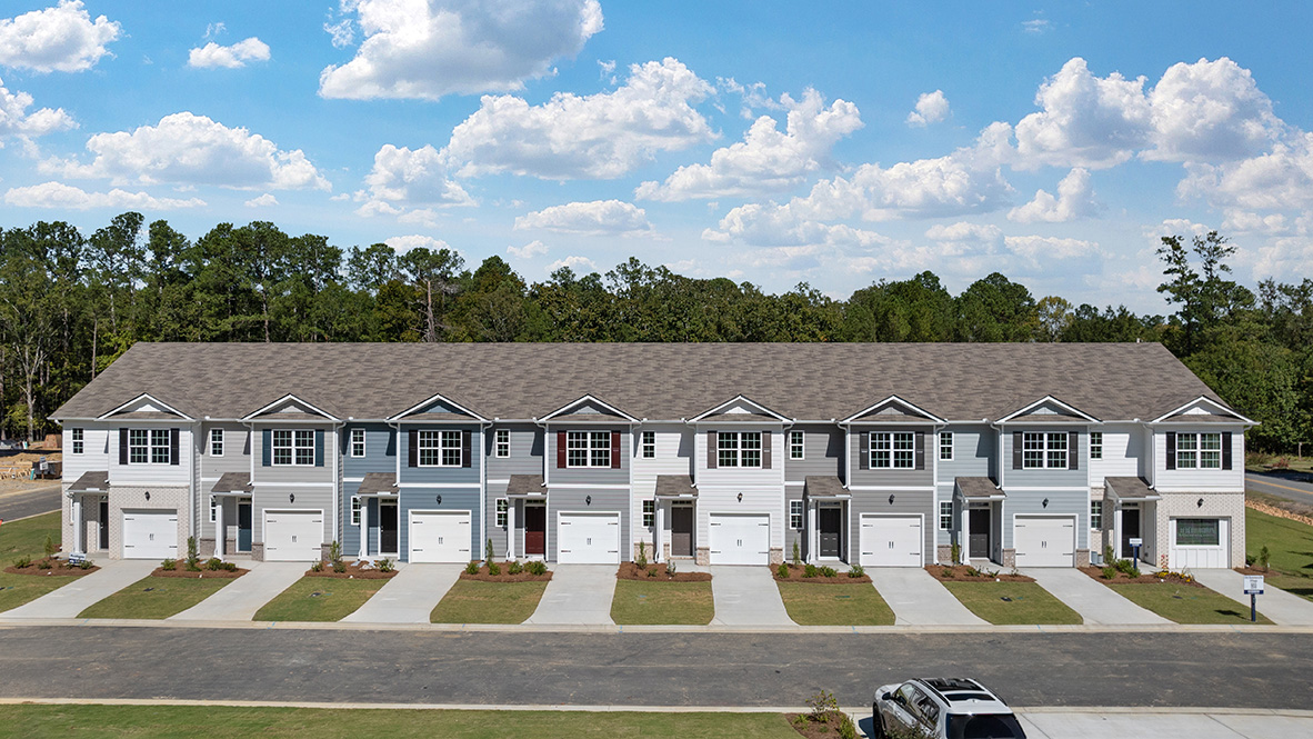 exterior front view of multi colored townhomes with a 1 car garage
