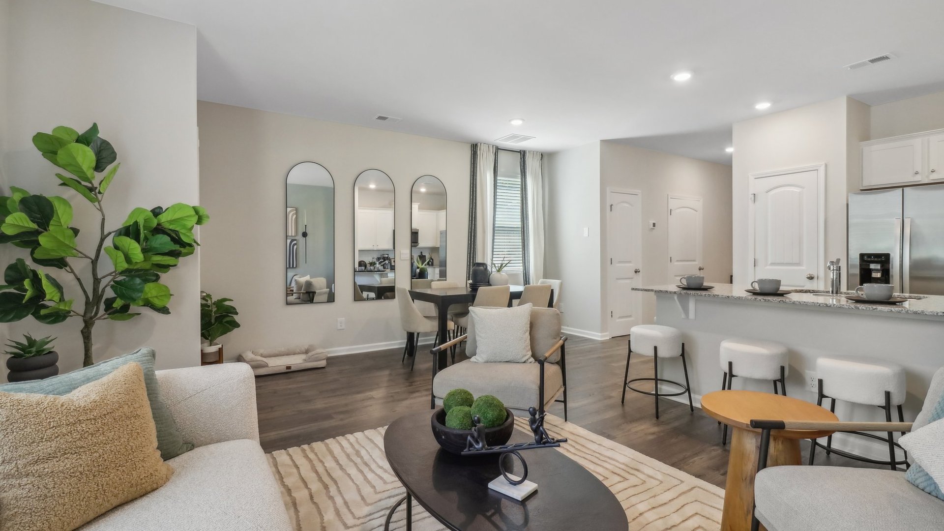 living room with light green accent wall, and light grey couches