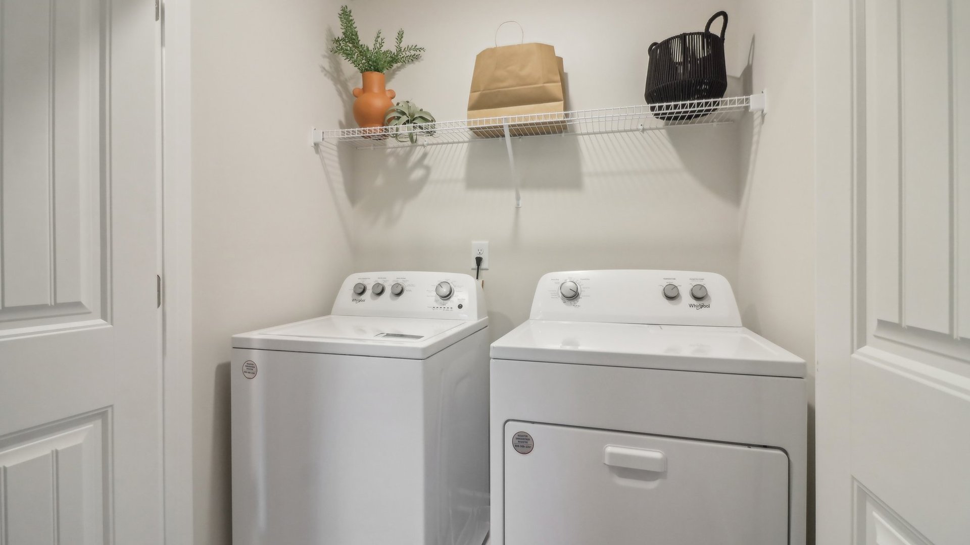 spacious laundry room with side by side washer and dryer