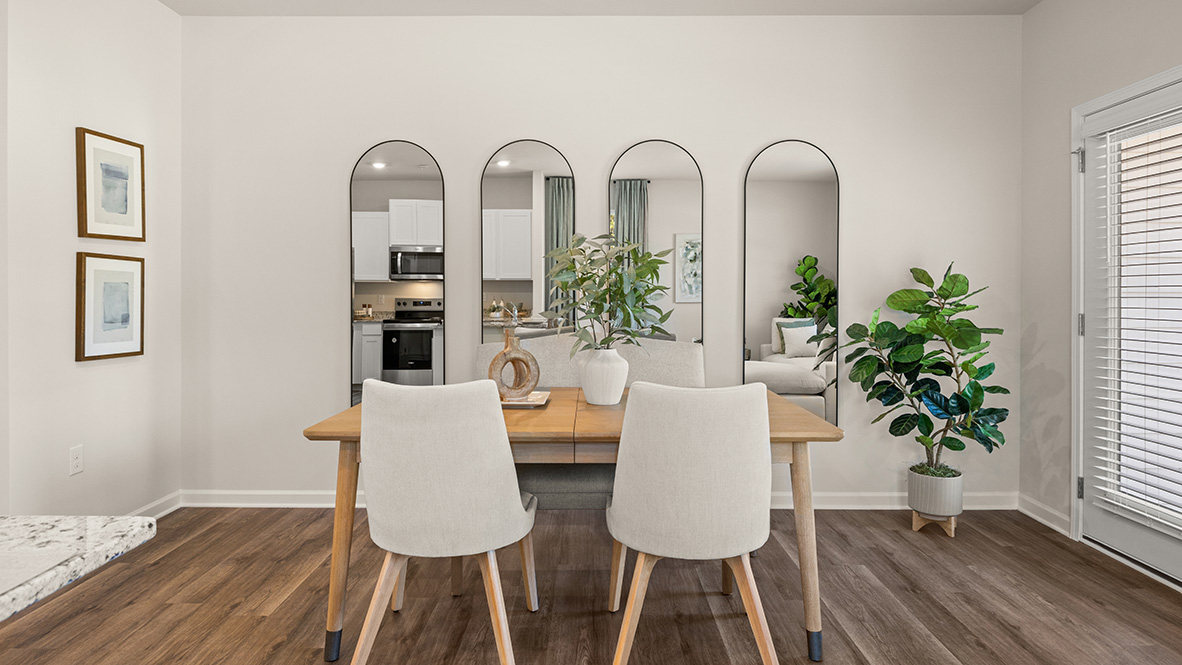dining room with a light wood table and 4 linen chairs
