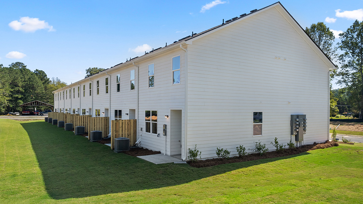 rear exterior view of home overlooking the green grass and homes nextdoor