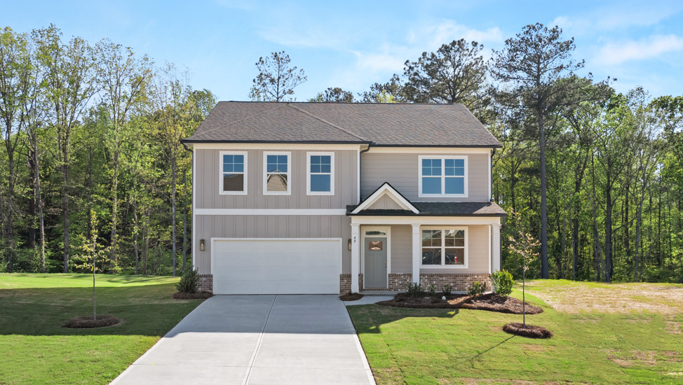 Exterior two-story home with cladding and stone detailing