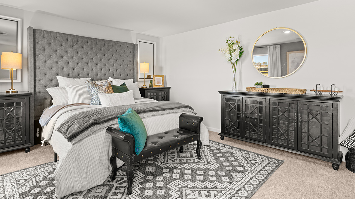 Primary bedroom with two windows.
