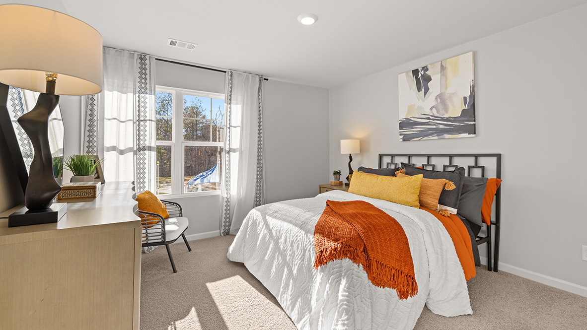 Third bedroom with double bed, double windows and tan dresser.