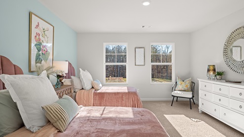 Third bedroom with double twin beds, double windows and white dresser.