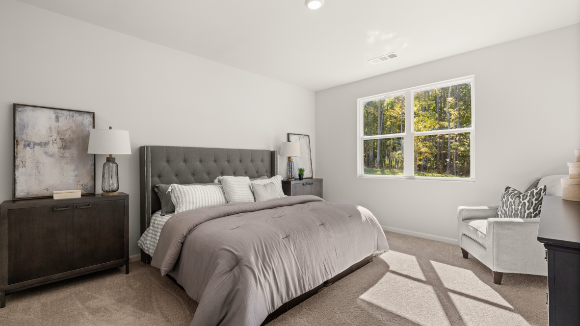 Interior primary bedroom with large window