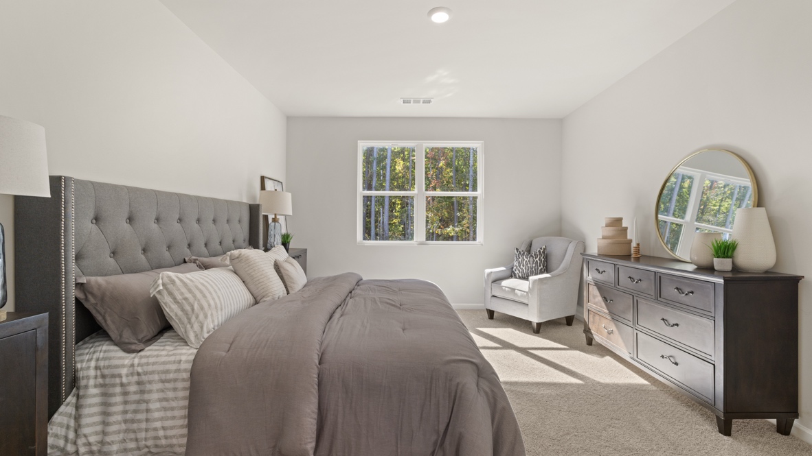 Interior primary bedroom with large window