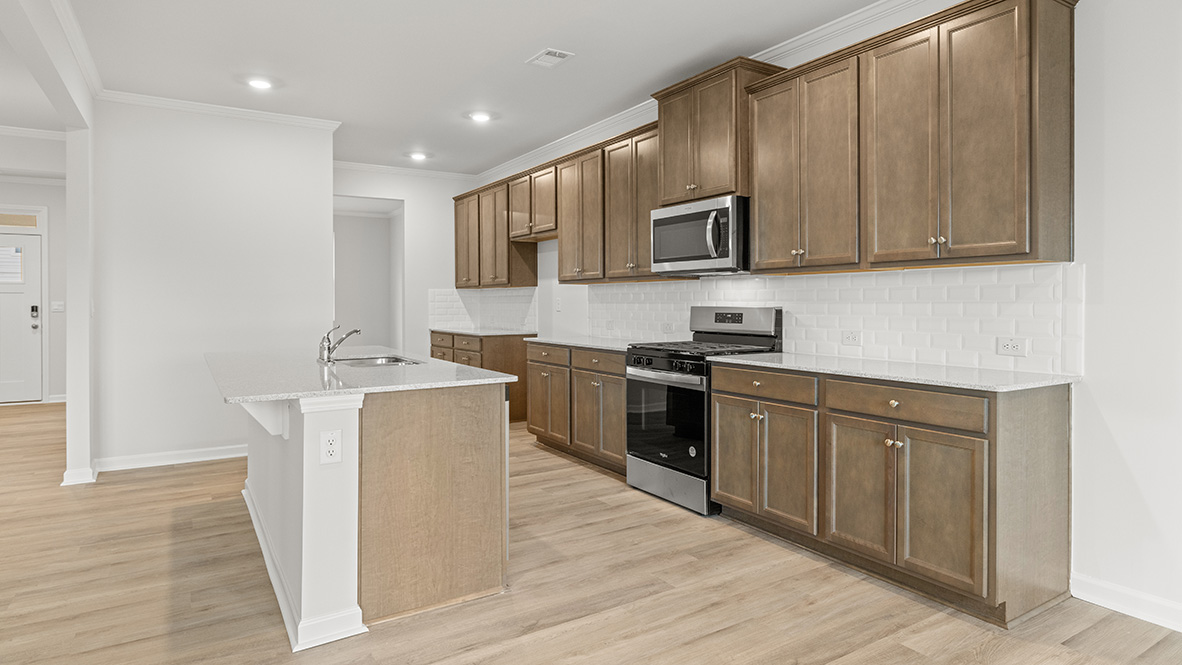 Interior kitchen with center island and wooden cabinets