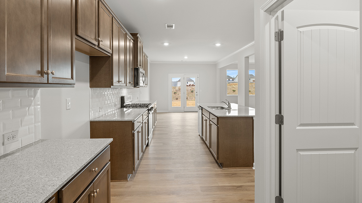 Interior kitchen with center island and wooden cabinets