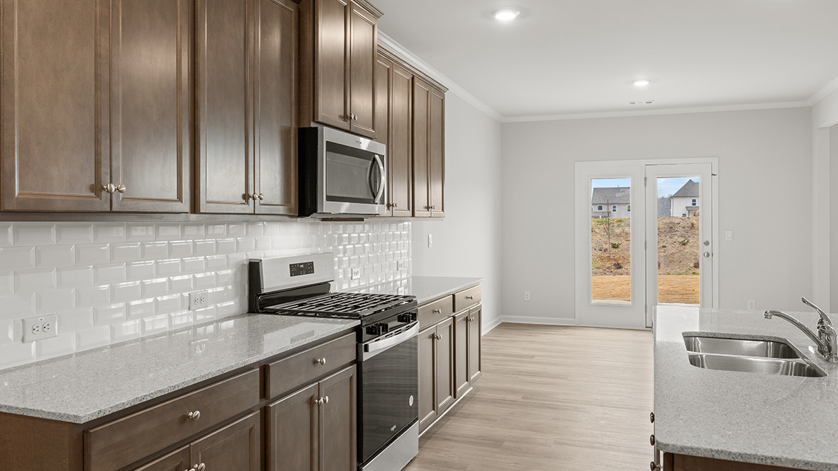 Interior kitchen with center island and wooden cabinets