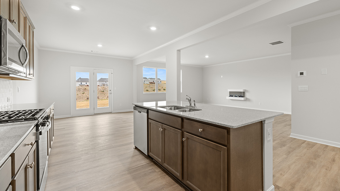 Interior kitchen with center island and wooden cabinets