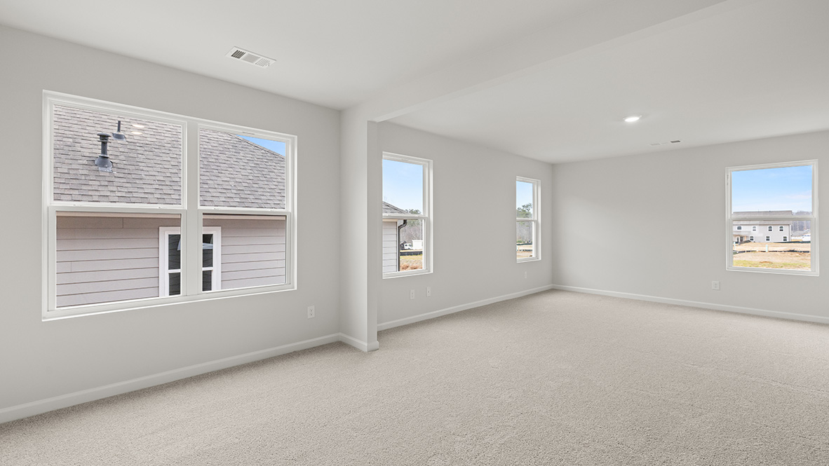 Interior primary bedroom with large windows