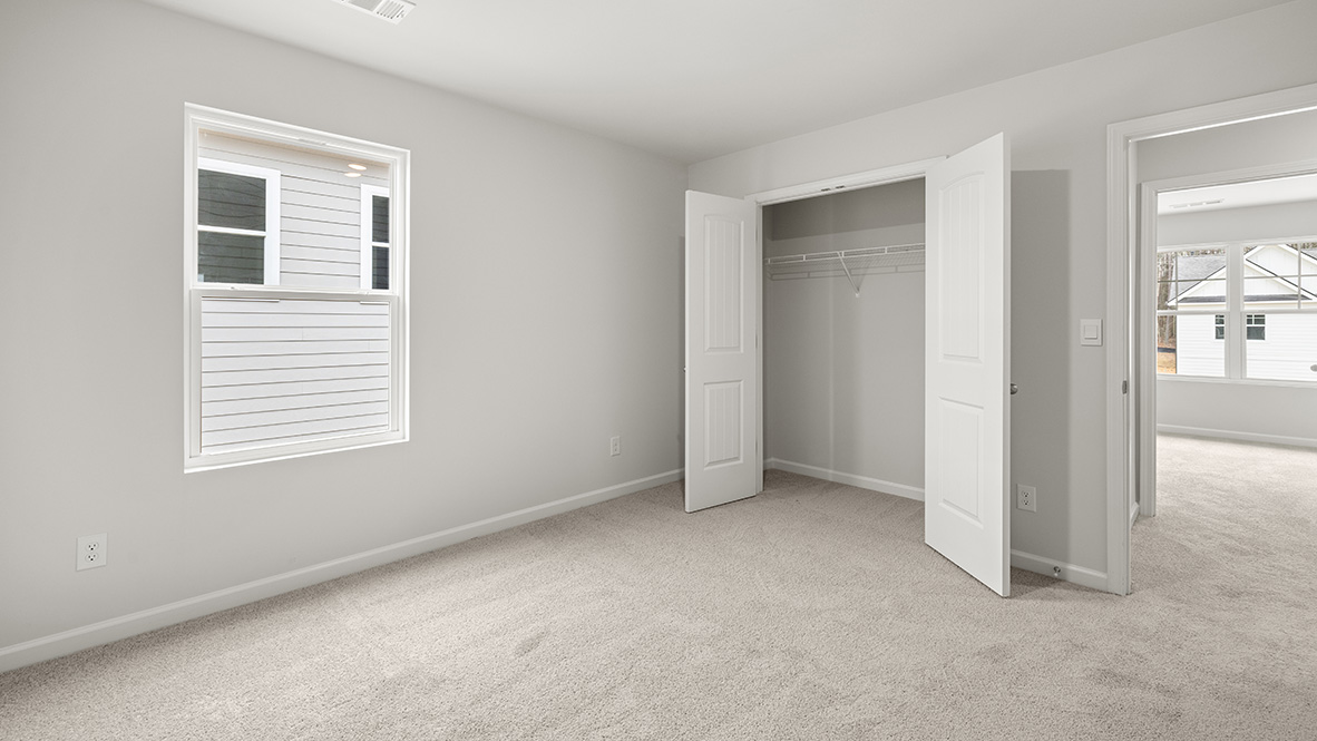 Interior bedroom with window and closet