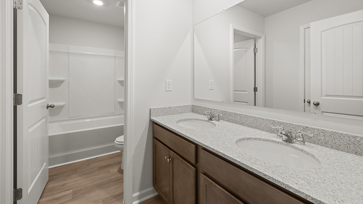 Interior bathroom with double sink and full-sized shower