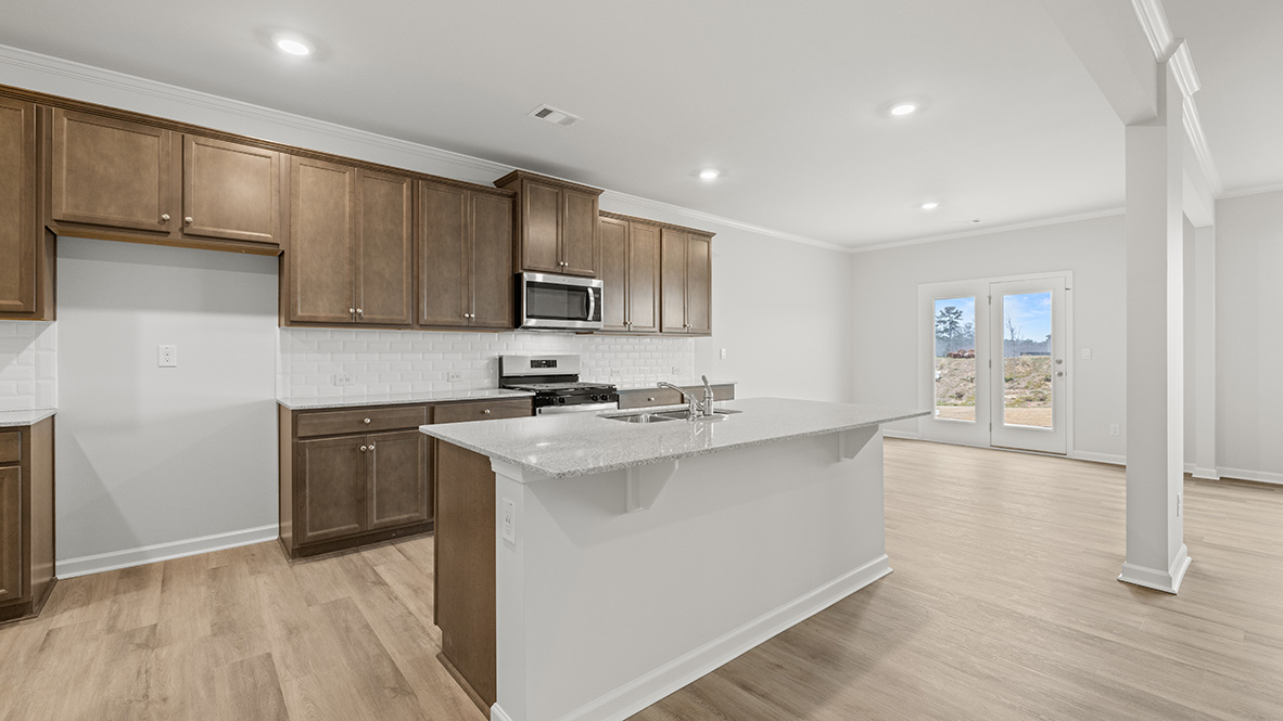 Interior kitchen with center island and wooden cabinets
