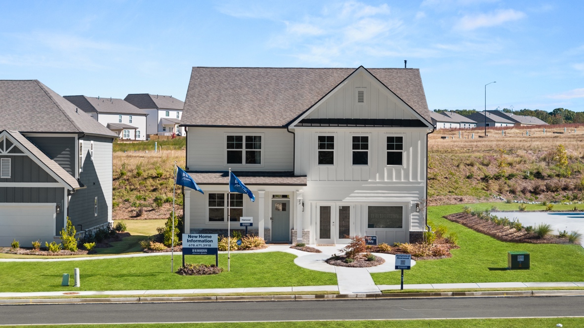 Exterior two-story home with cladding and stone detailing