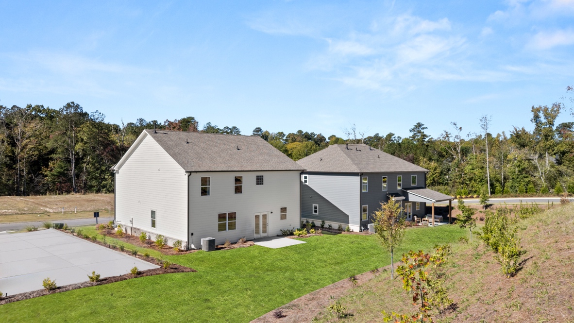 Exterior rear view of two-story home and back yard