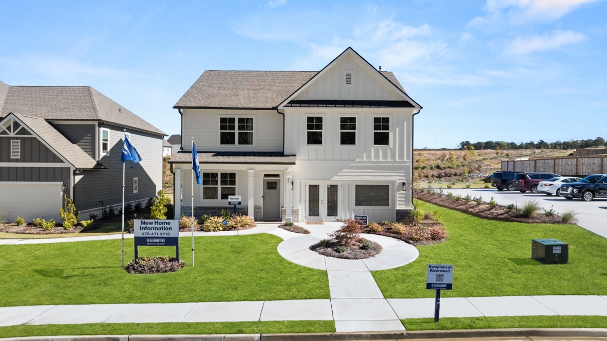 Exterior two-story home with cladding and stone detailing