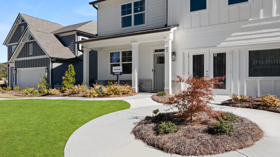 Exterior two-story home with cladding and stone detailing