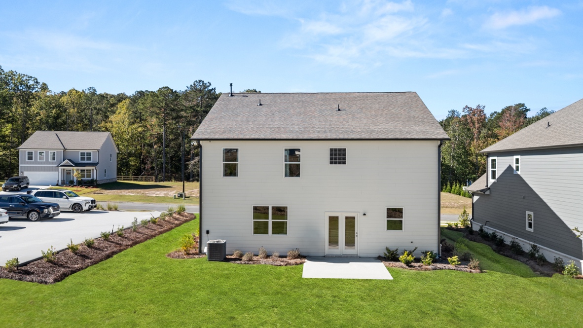 Exterior rear view of two-story home and back yard