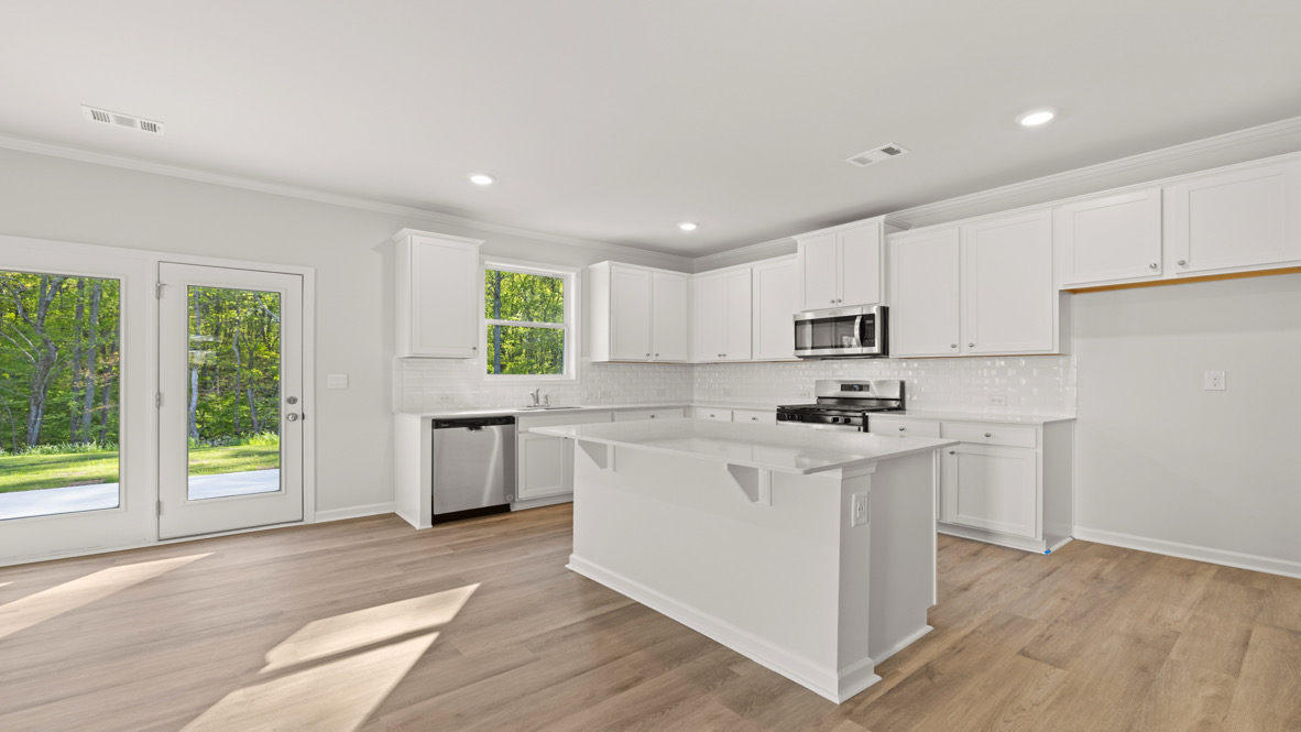 Interior kitchen with center island and white cabinets