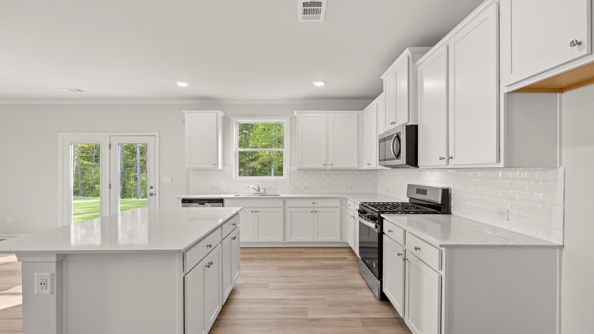Interior kitchen with center island and white cabinets
