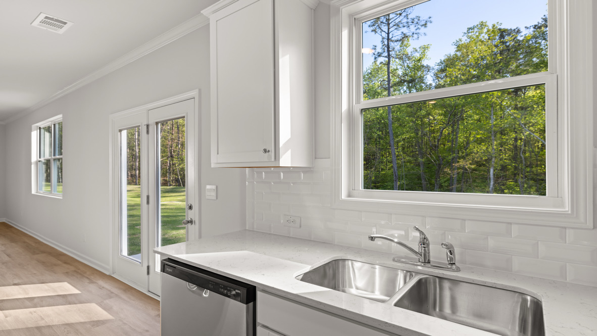 Interior kitchen with center island and white cabinets