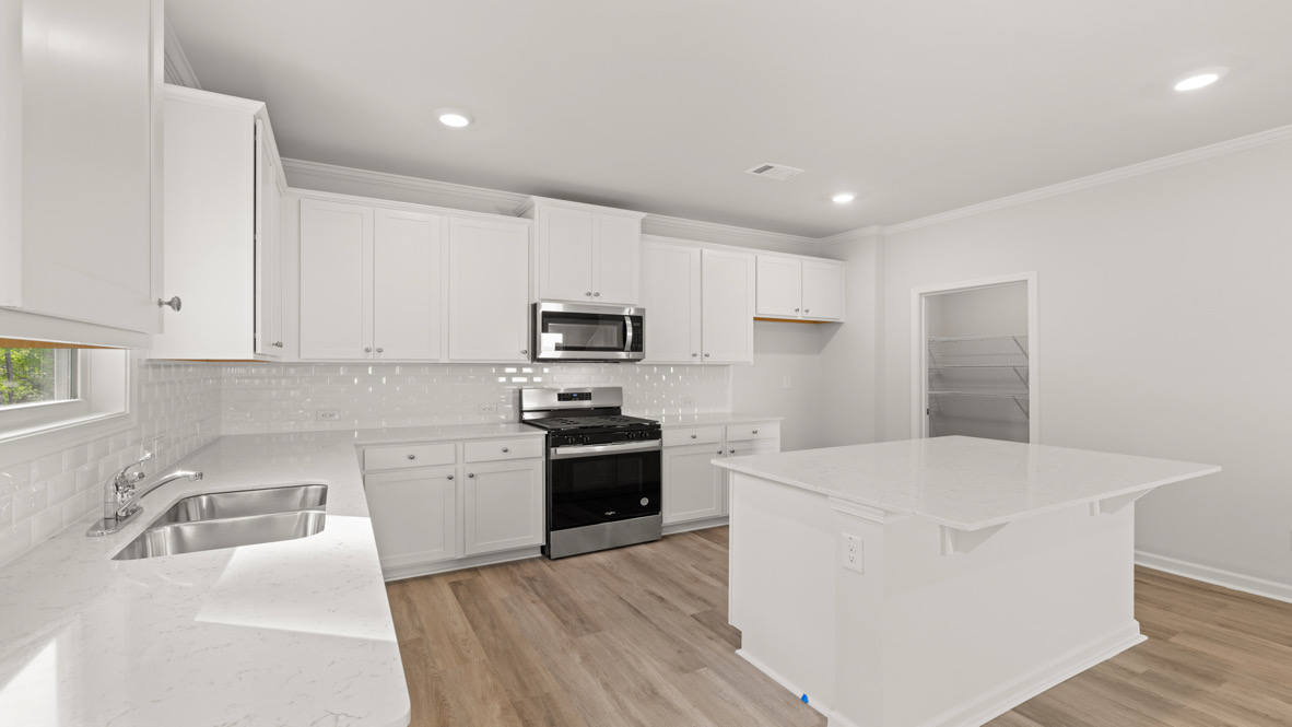 Interior kitchen with center island and white cabinets
