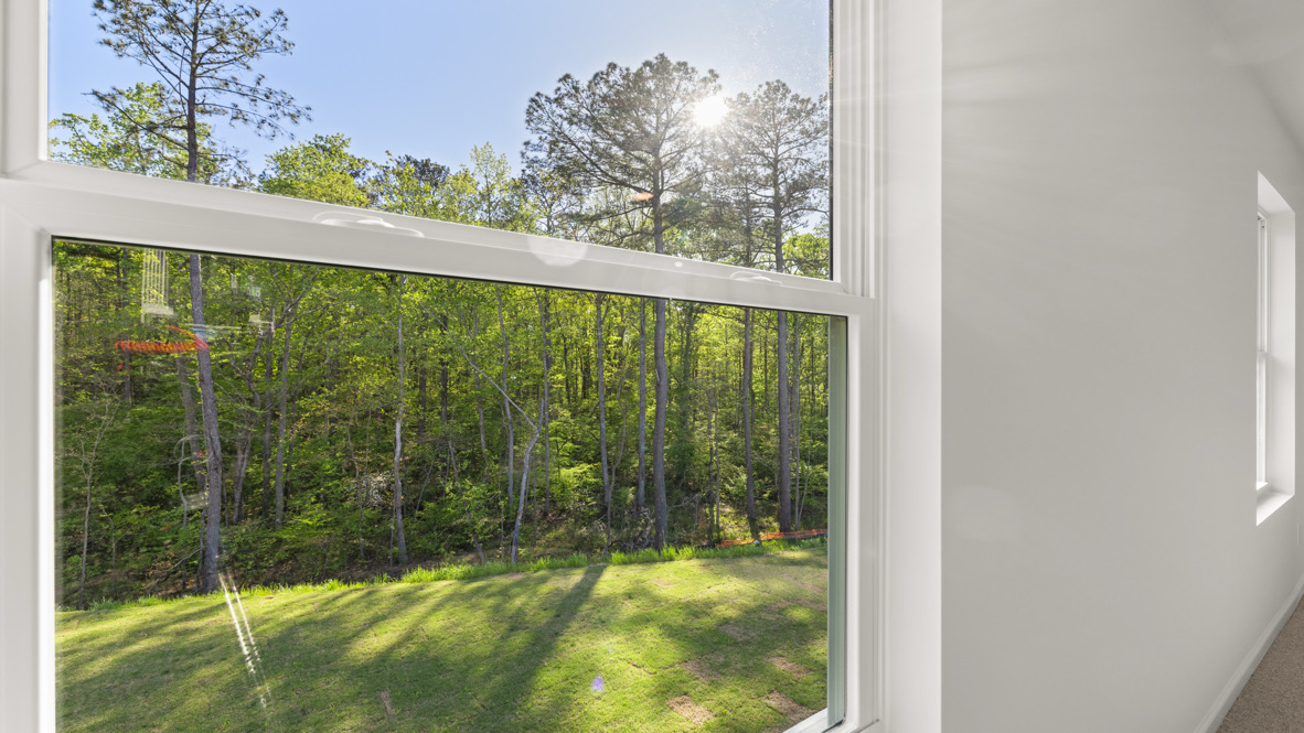 Interior primary bedroom with large windows