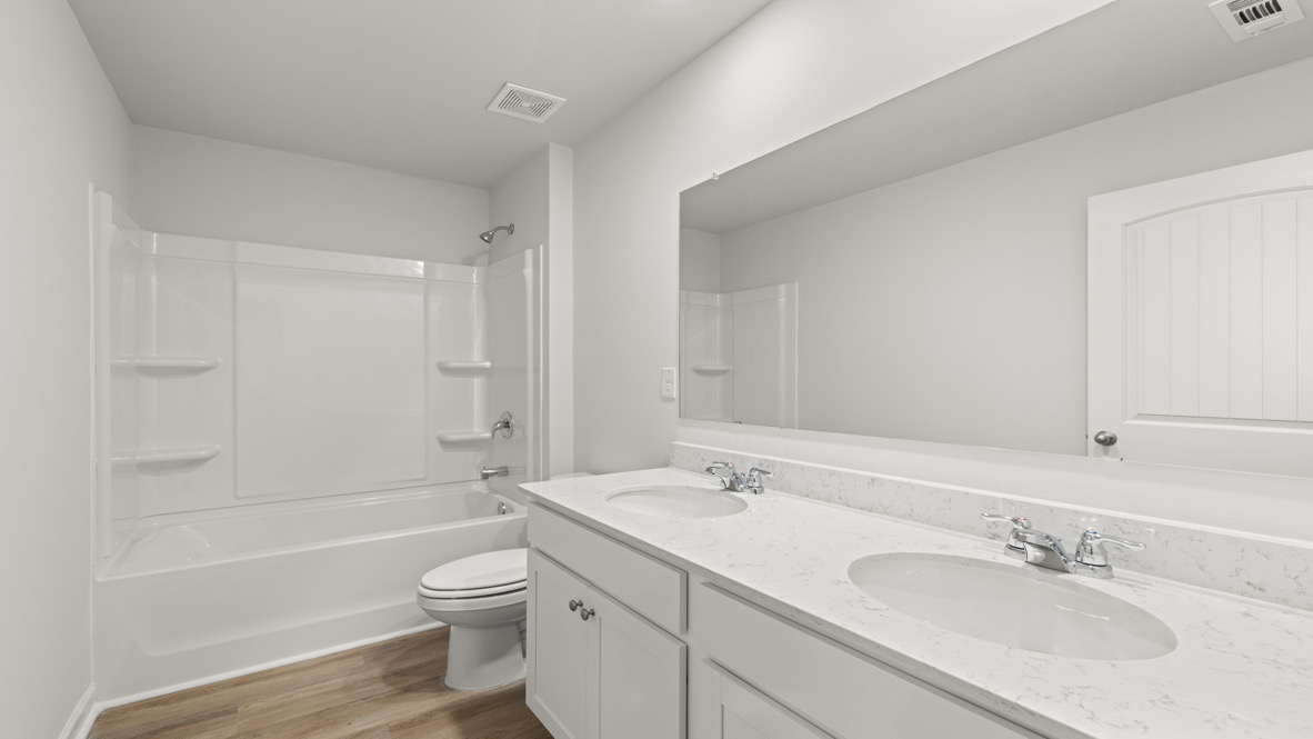 Interior bathroom with double sink and full-sized shower