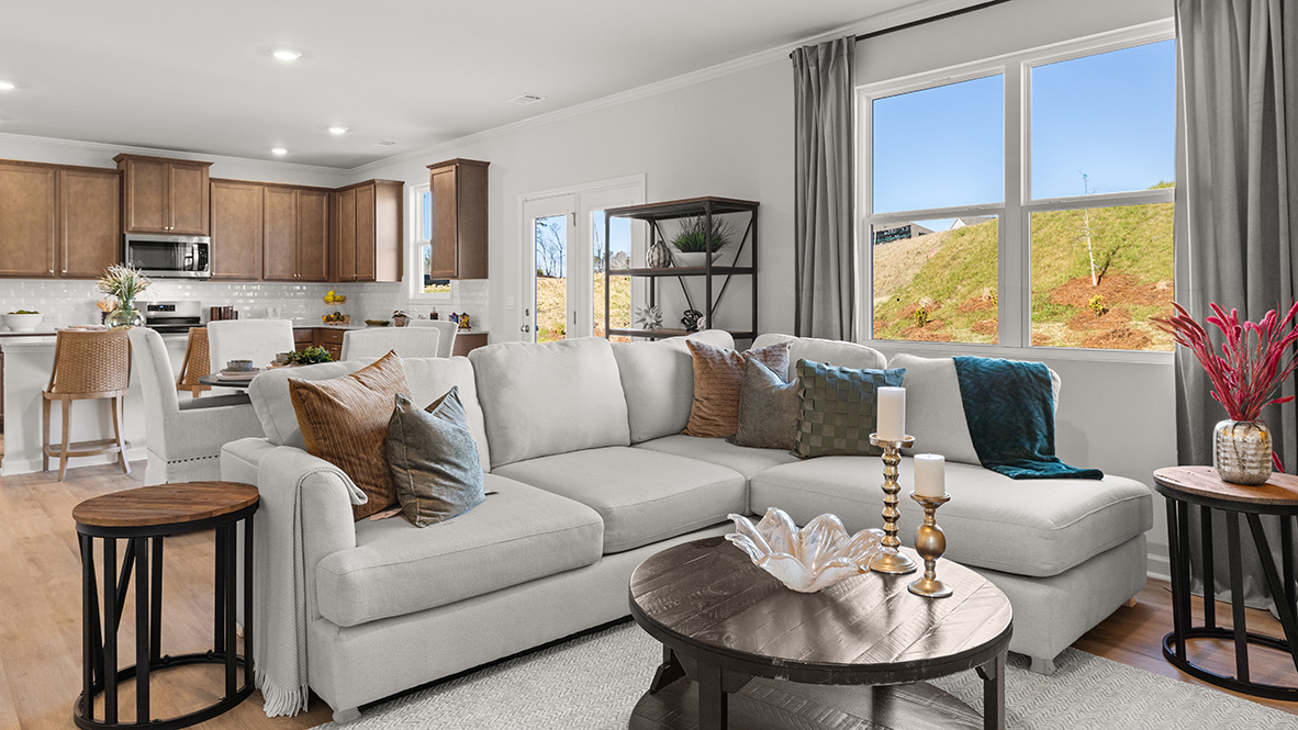 Interior living area with large window open to dining area and kitchen