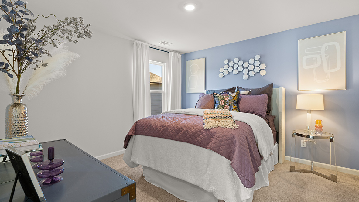 Interior upstairs bedroom with window and accent wall