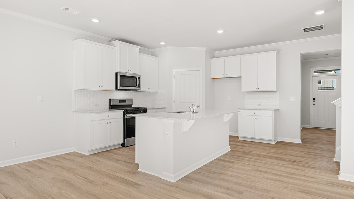 Interior kitchen with center island and white cabinets