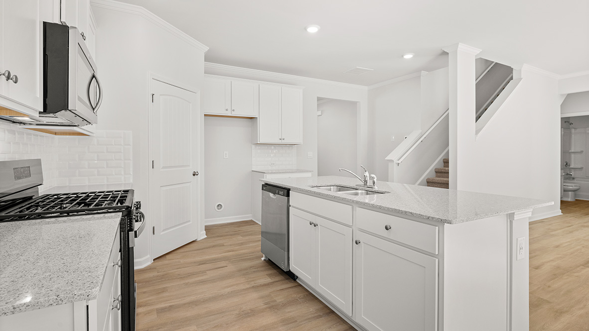 Interior kitchen with center island and white cabinets