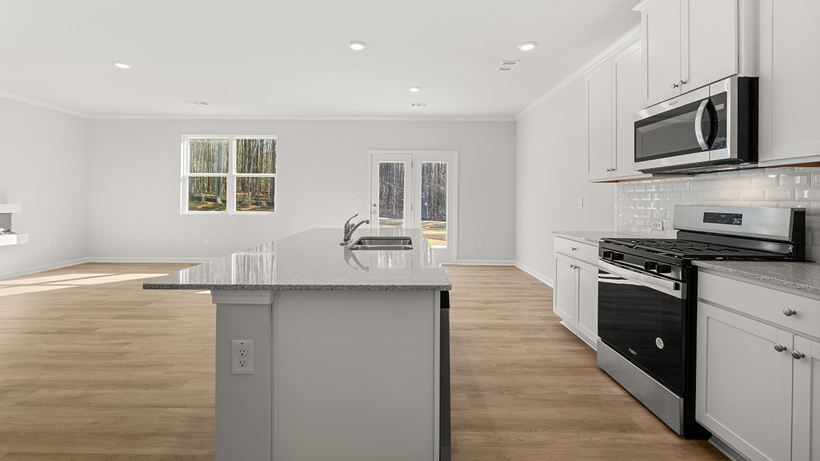 Interior kitchen with center island and white cabinets