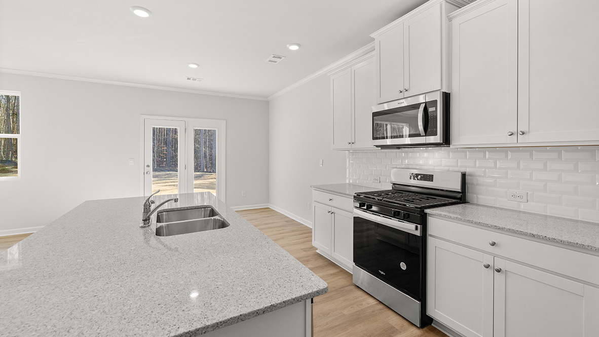 Interior kitchen with center island and white cabinets