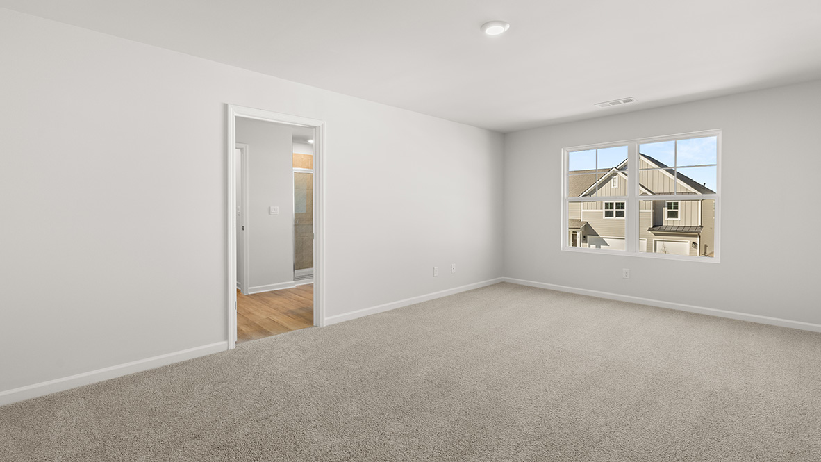 Interior primary bedroom with large window