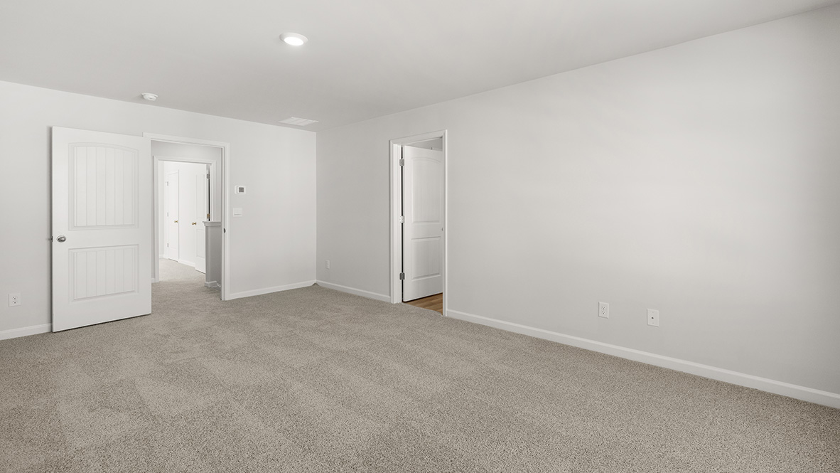 Interior primary bedroom with bathroom