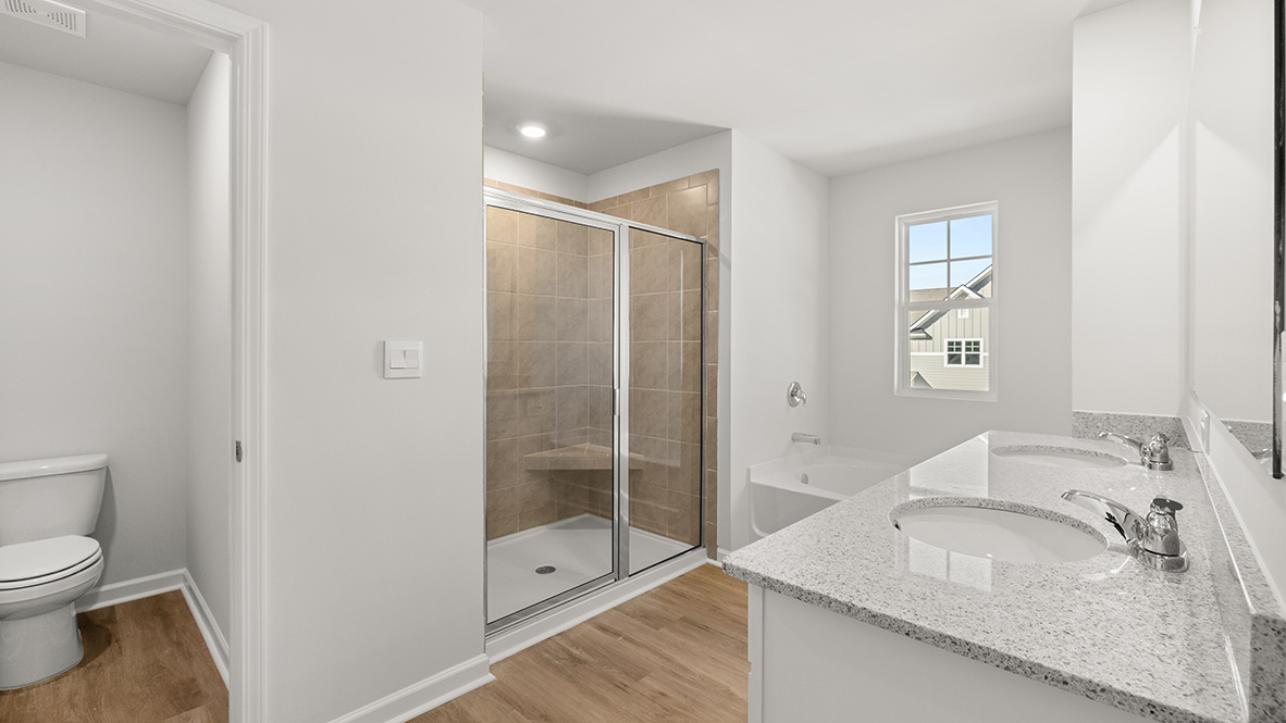 Interior primary bathroom with double sink and shower