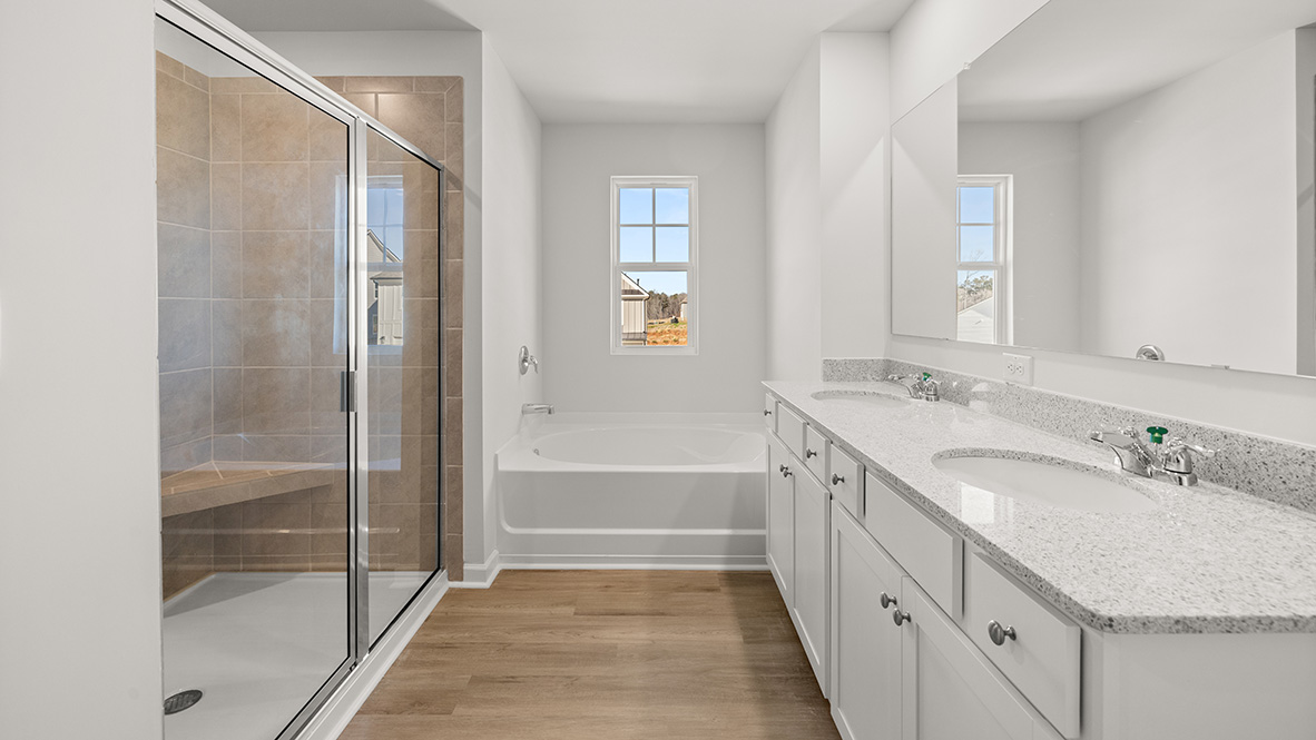 Interior primary bathroom with double sink and shower