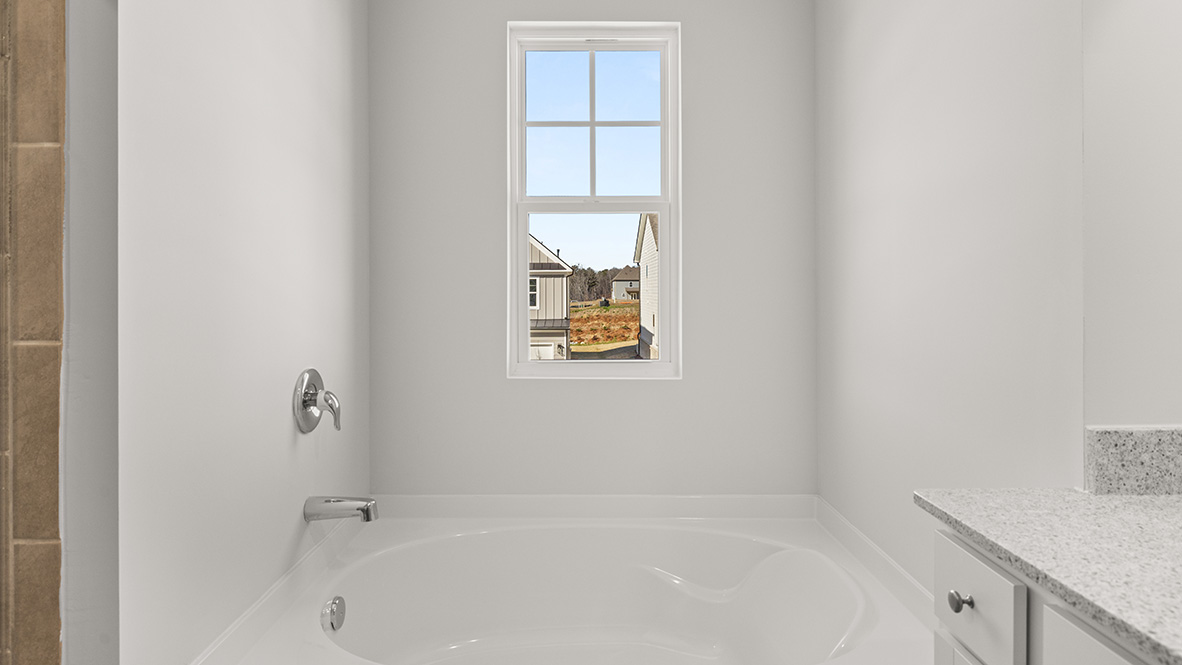 Interior primary bathroom with bath tub