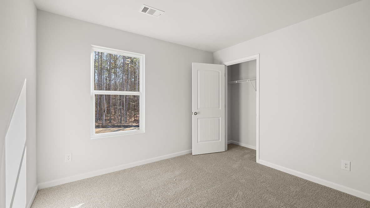 Interior bedroom with window and closet