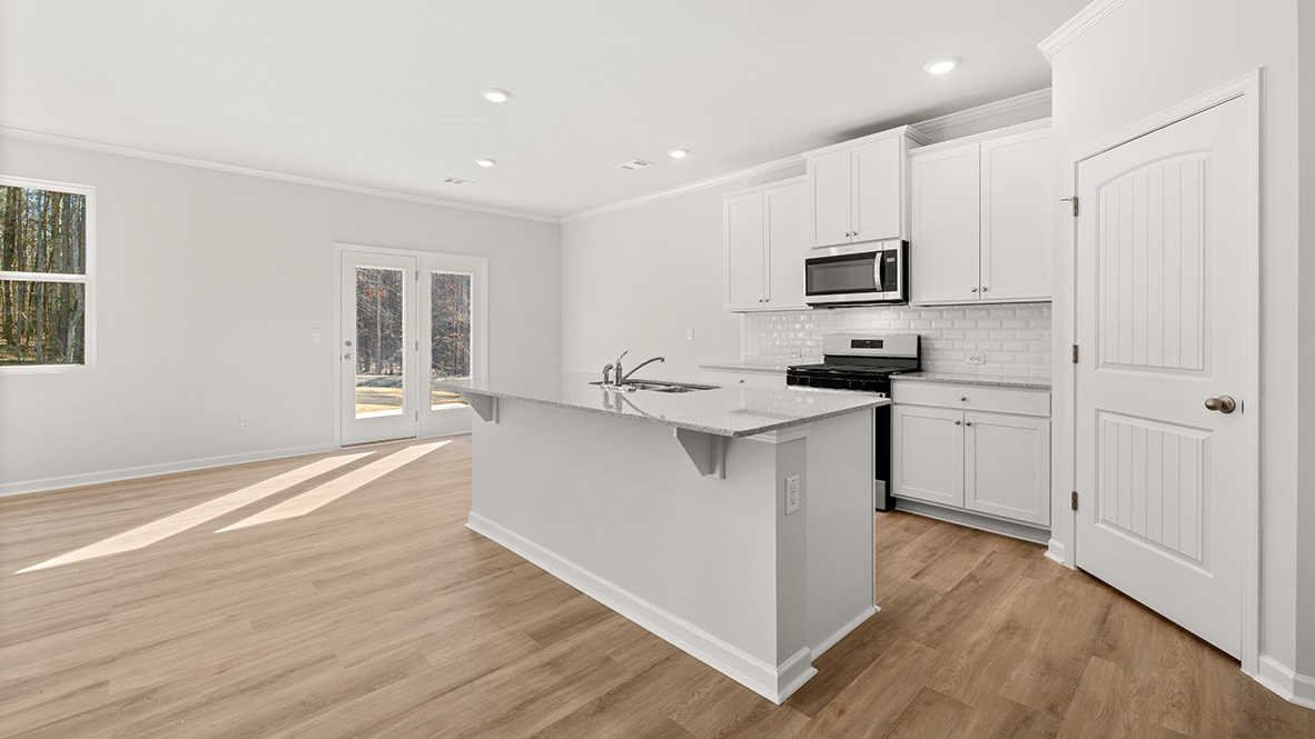 Interior kitchen with center island and white cabinets
